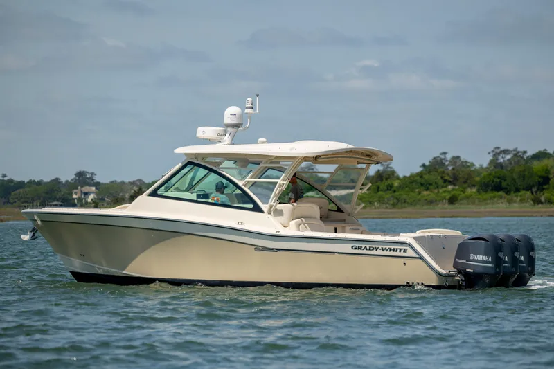 Slide: The Image of 2015 Grady-White Freedom 375 boat cruising on water with Yamaha engines. - 4