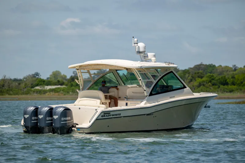 Slide: The Image of 2015 Grady-White Freedom 375 boat cruising on a calm lake. - 7