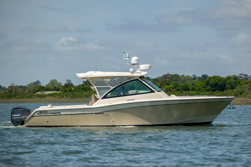 Slide: The Image of 2015 Grady-White Freedom 375 boat cruising on a calm lake. - 8