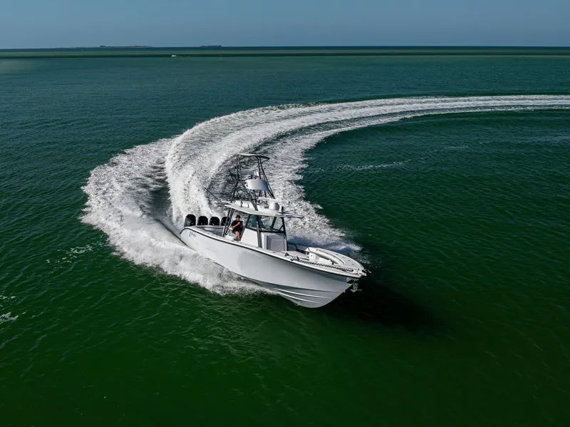 Slide: The Image of 2023 Yellowfin 39 Offshore boat making a sharp turn on open water. - 10