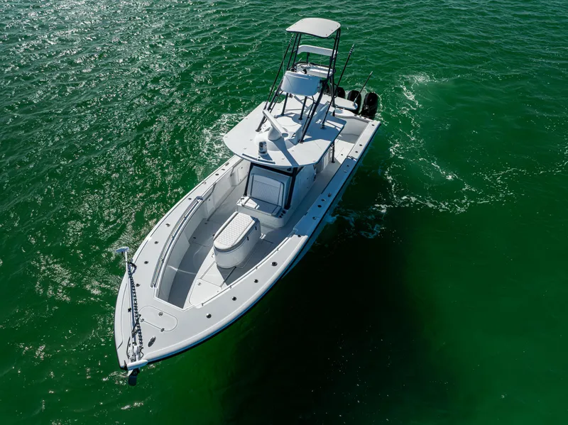 Slide: The Image of 2023 Yellowfin 39 Offshore boat cruising on clear green water. - 11