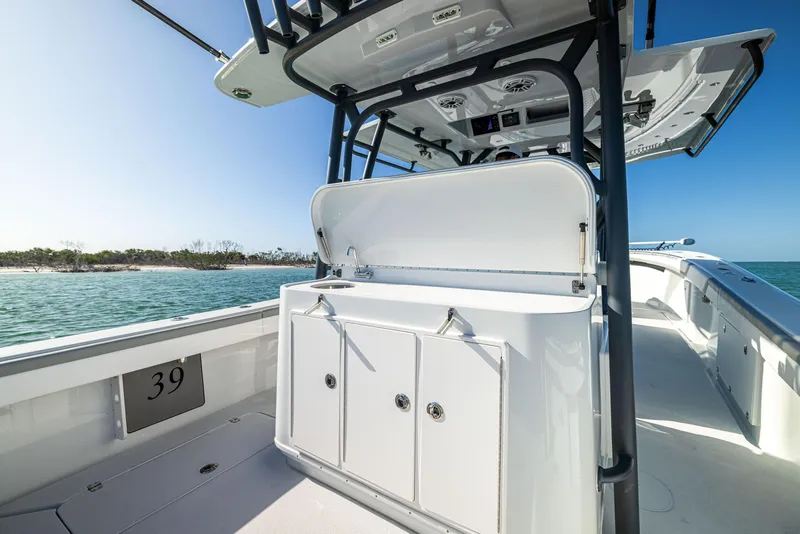 Slide: The Image of 2023 Yellowfin 39 Offshore boat interior with storage, open sea view. - 20