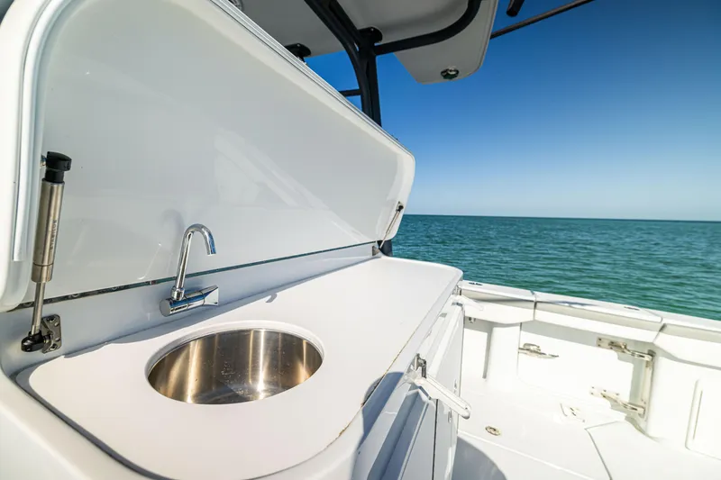 Slide: The Image of 2023 Yellowfin 39 Offshore boat with sink, ocean view, and clear blue sky. - 21