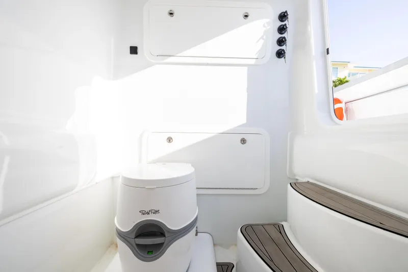 Slide: The Image of 2023 Yellowfin 39 Offshore boat interior with compact toilet and storage compartments. - 28