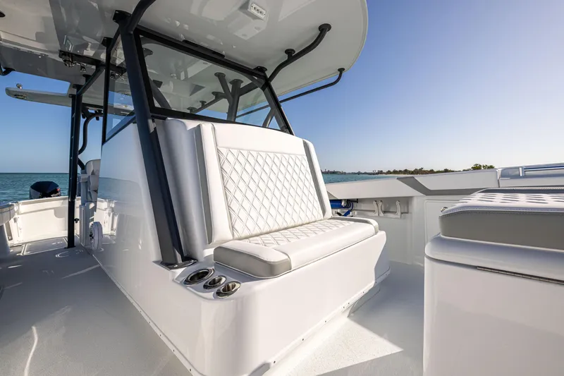 Slide: The Image of 2023 Yellowfin 39 Offshore boat interior with cushioned seating and ocean view. - 30
