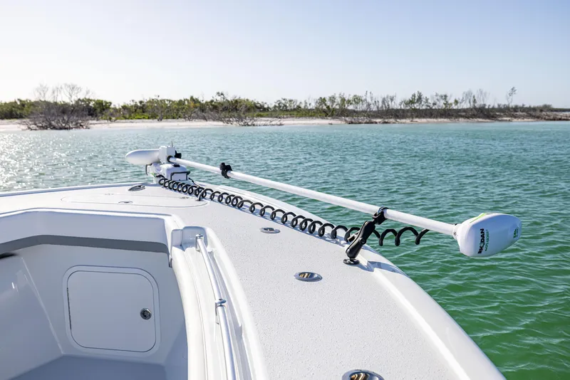 Slide: The Image of 2023 Yellowfin 39 Offshore boat on calm water near a sandy shoreline. - 35