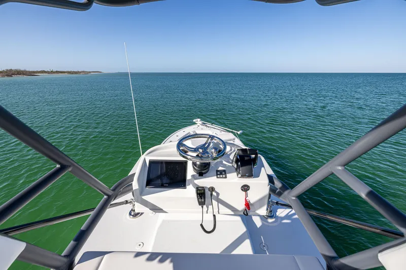 Slide: The Image of 2023 Yellowfin 39 Offshore boat helm overlooking calm ocean waters. - 41