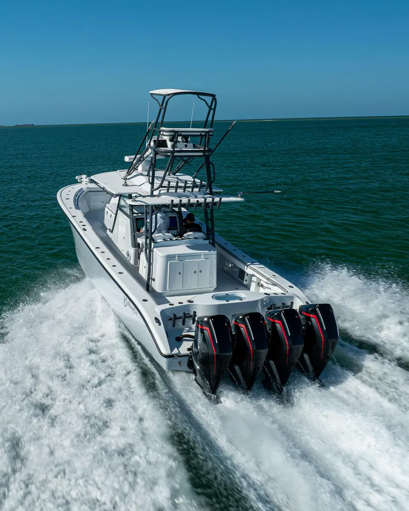 Slide: The Image of 2023 Yellowfin 39 Offshore boat cruising on open water with four powerful engines. - 9