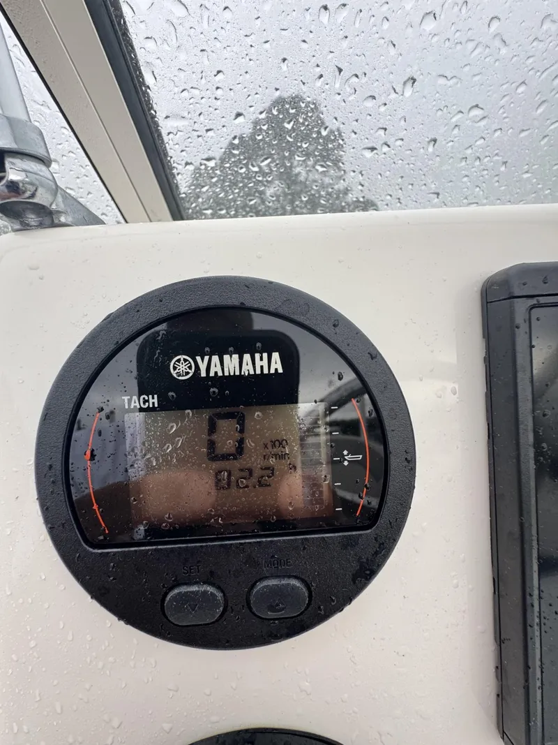 Slide: The Image of Yamaha tachometer on a 2021 Key West 203 DFS boat, wet from rain. - 7