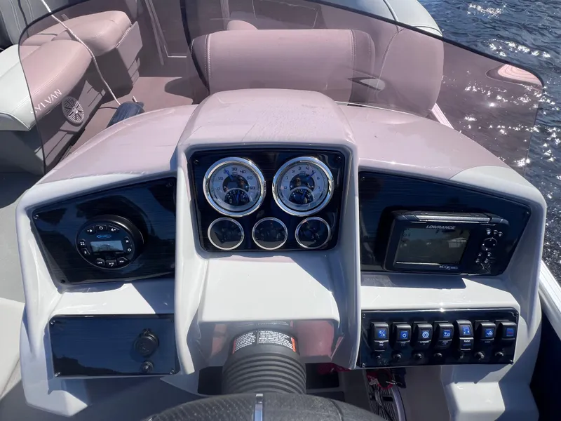 Slide: The Image of 2022 Sylvan Mirage 820 PARTY FISH dashboard with gauges and controls on a sunny day. - 21