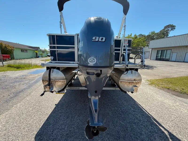 Slide: The Image of 2022 Sylvan Mirage 820 PARTY FISH pontoon boat with Yamaha 90 engine, parked outdoors. - 6