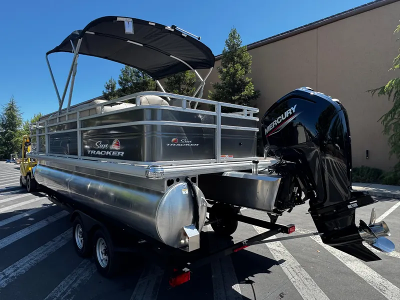 Slide: The Image of 2025 Sun Tracker Fishin' Barge 20 DLX pontoon boat with Mercury outboard motor. - 2