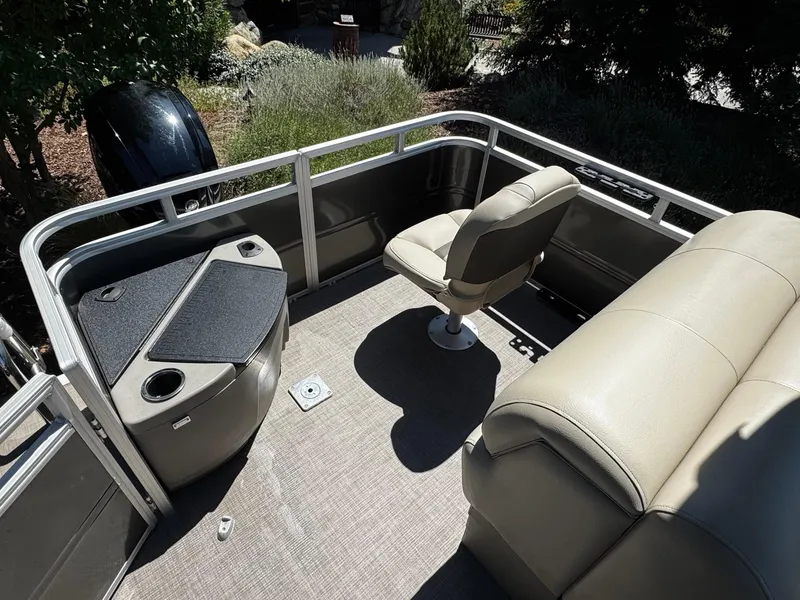 Slide: The Image of 2025 Sun Tracker Fishin' Barge 20 DLX interior with seating and storage. - 5