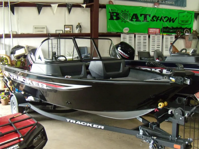 The Image of 2025 Tracker Pro Guide V-16 WT boat displayed at a boat show indoors. - 0
