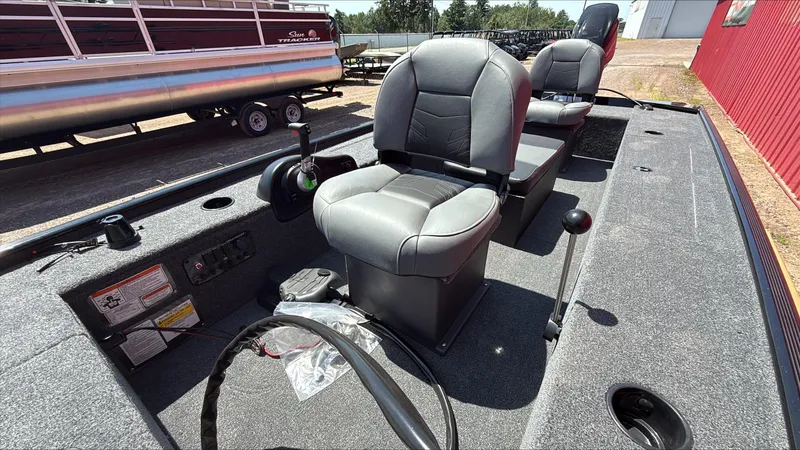 Slide: The Image of 2025 Tracker Panfish 17 boat interior with gray seating and control panel. - 2