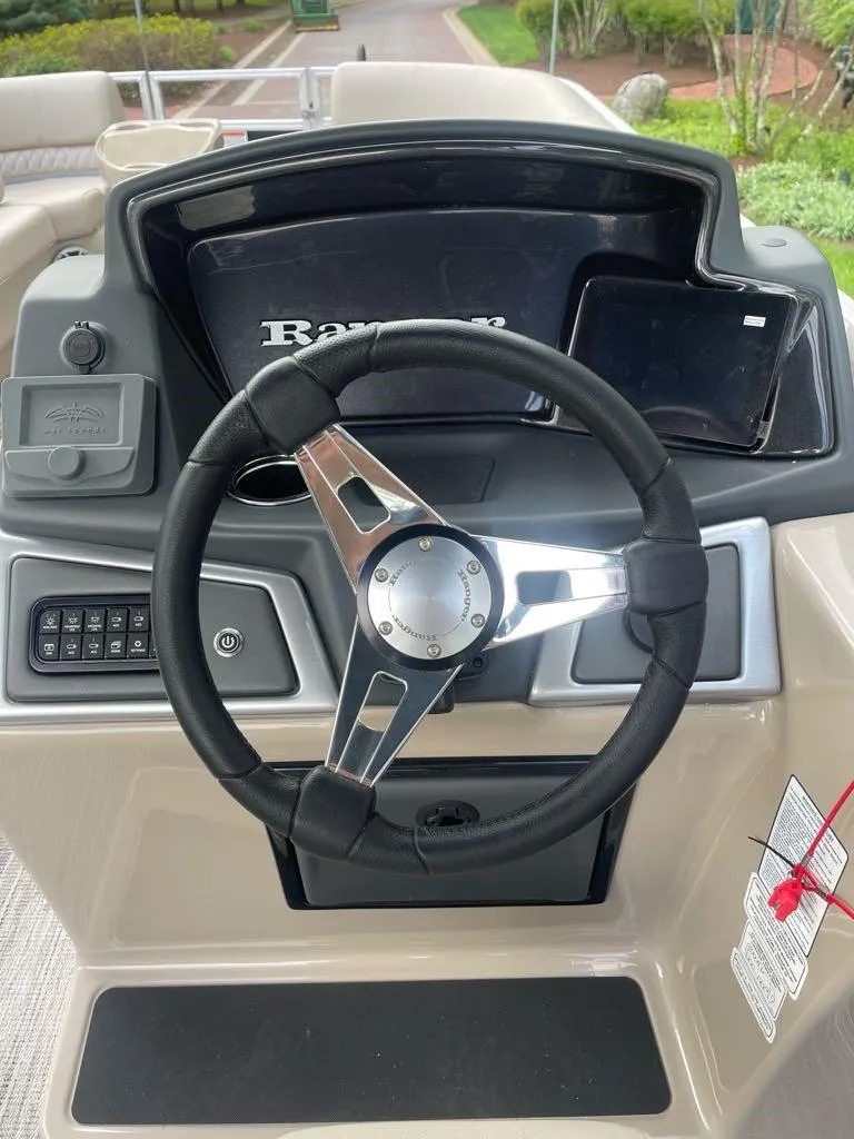 Slide: The Image of Steering console of 2025 Ranger Reata 220C boat with modern controls and sleek design. - 4