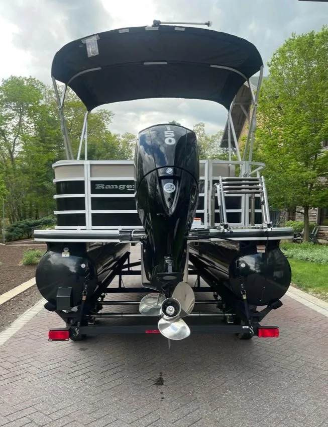 Slide: The Image of 2025 Ranger Reata 220C pontoon boat with canopy and powerful outboard motor. - 7