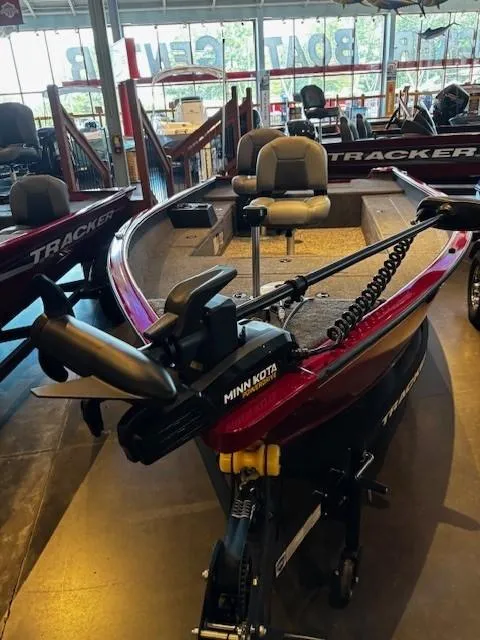 Slide: The Image of 2025 Tracker Super Guide V-16 T boat with Minn Kota motor in showroom. - 3