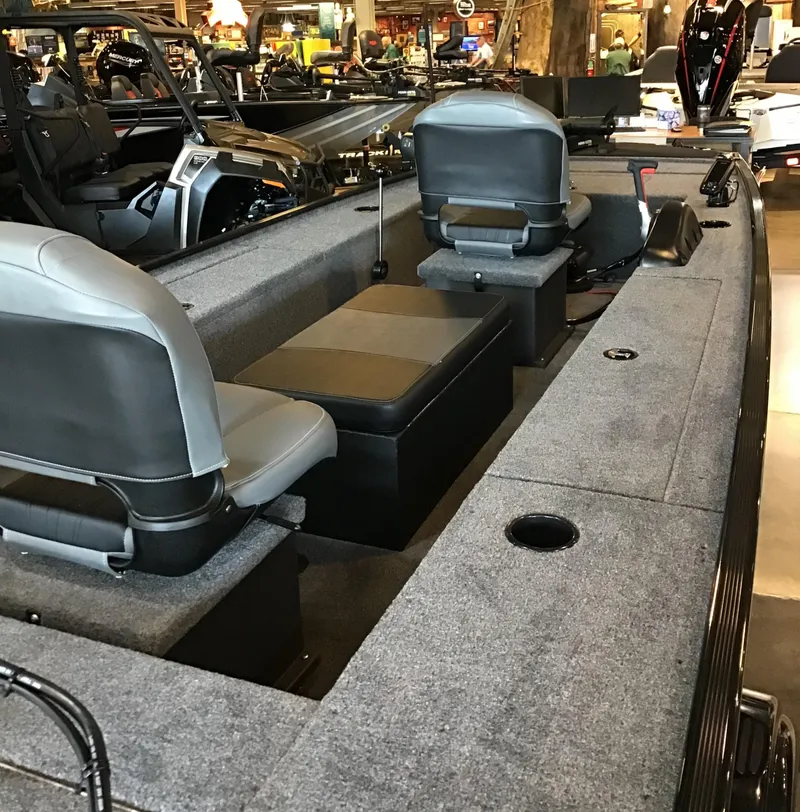 Slide: The Image of 2025 Tracker Panfish 17 boat interior with seating and storage compartments. - 2