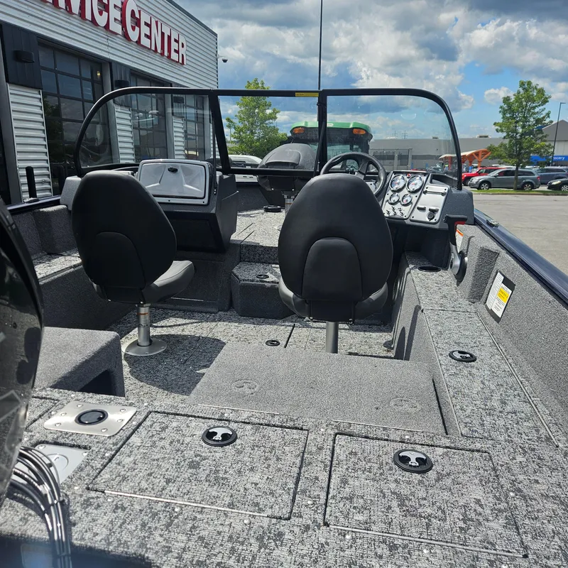 Slide: The Image of 2025 Tracker Pro Guide V-175 Combo boat interior with seating and control panel. - 2