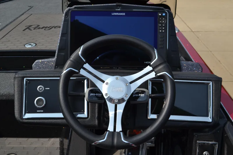 Slide: The Image of 2025 Ranger Z521R Cup-Equipped boat dashboard with steering wheel and digital displays. - 3