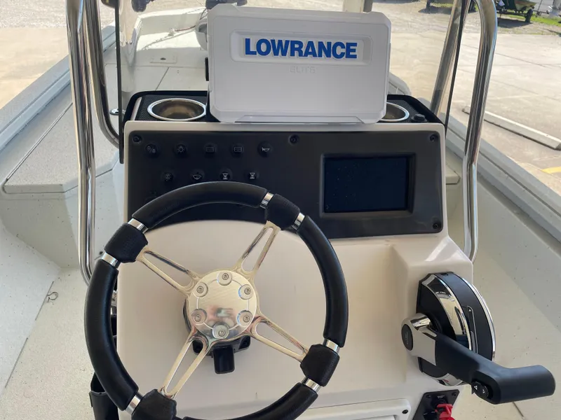 Slide: The Image of 2025 Ranger RB210 boat console with steering wheel, Lowrance device, and control panel. - 13