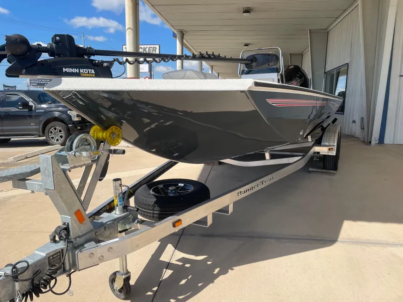 Slide: The Image of 2025 Ranger RB210 boat on trailer, featuring Minn Kota motor, parked outdoors. - 3