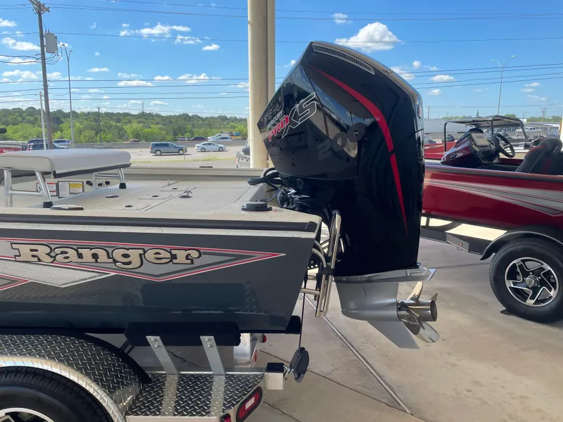 Slide: The Image of 2025 Ranger RB210 boat with powerful outboard motor, displayed outdoors on a sunny day. - 5