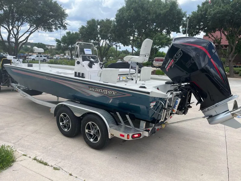 Slide: The Image of 2025 Ranger RB210 boat on trailer, featuring powerful outboard motor, parked outdoors. - 4