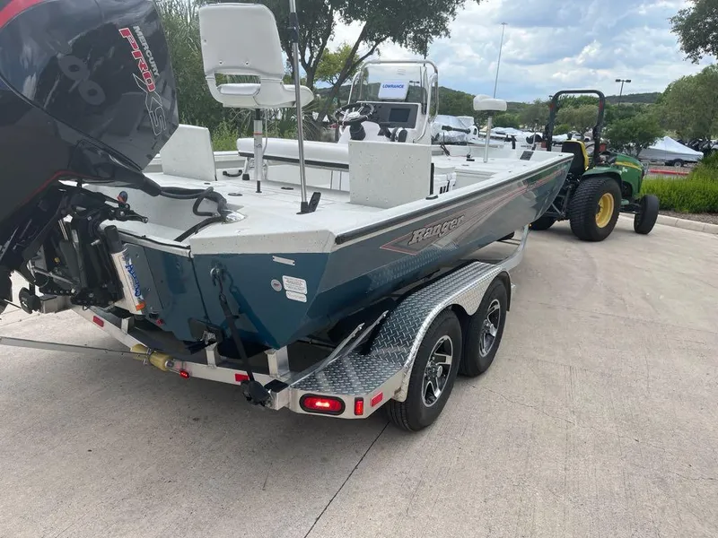 Slide: The Image of 2025 Ranger RB210 boat on trailer, featuring powerful outboard motor. - 5