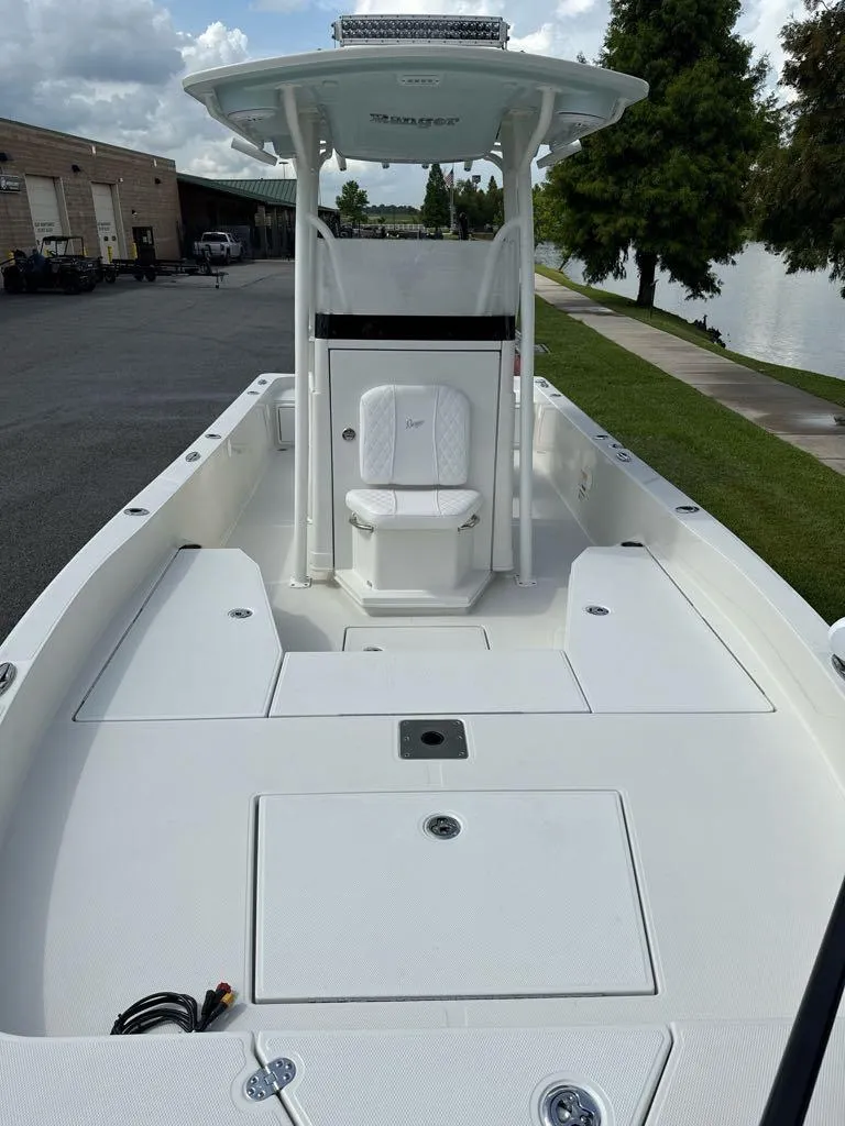 Slide: The Image of 2025 Ranger 2360 Bay boat, white deck, center console, parked near water. - 3