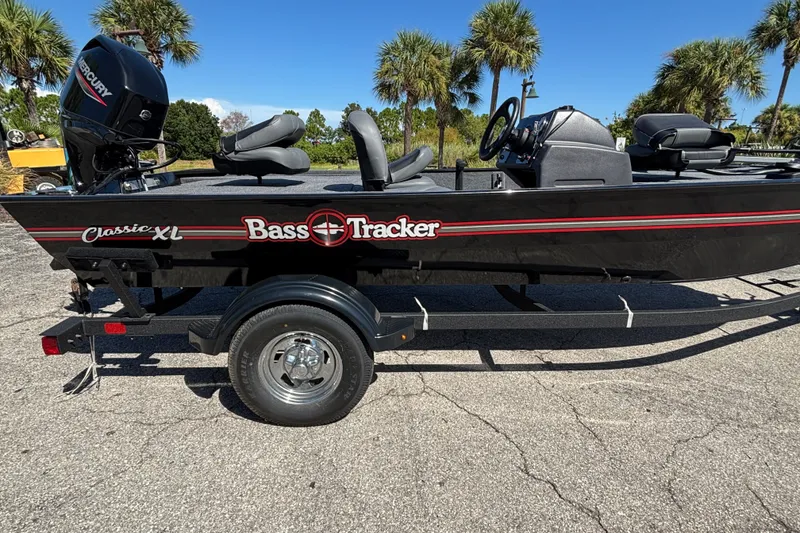 The Image of 2025 Tracker Bass Tracker Classic XL boat on trailer, parked outdoors with palm trees. - 0
