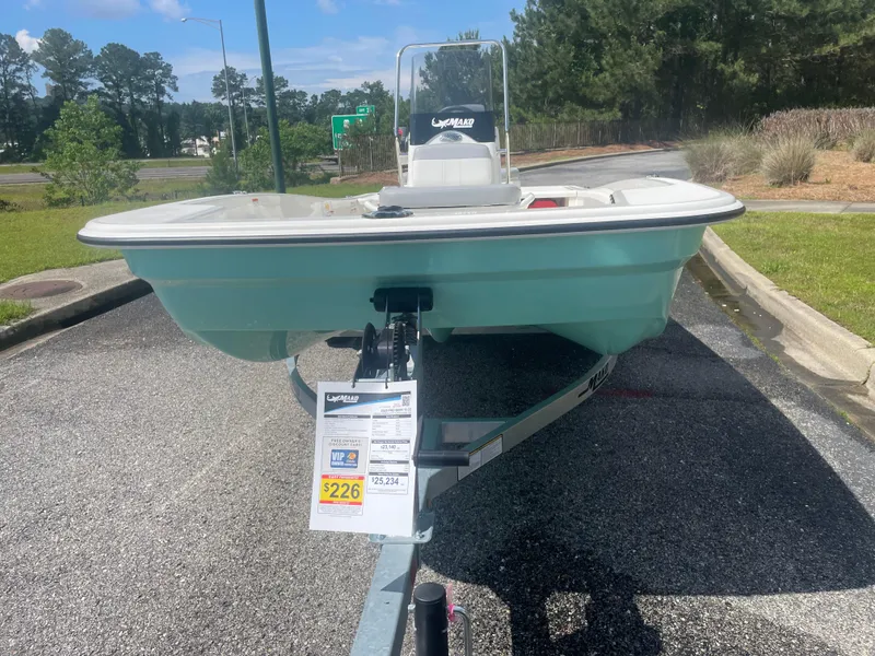 Slide: The Image of 2025 Mako Pro Skiff 15 CC boat on trailer in outdoor setting. - 4