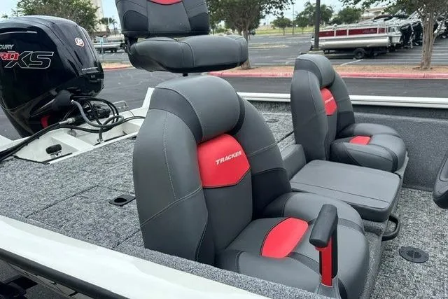 Slide: The Image of 2025 Tracker Pro Team 190 boat interior with gray and red seating. - 5