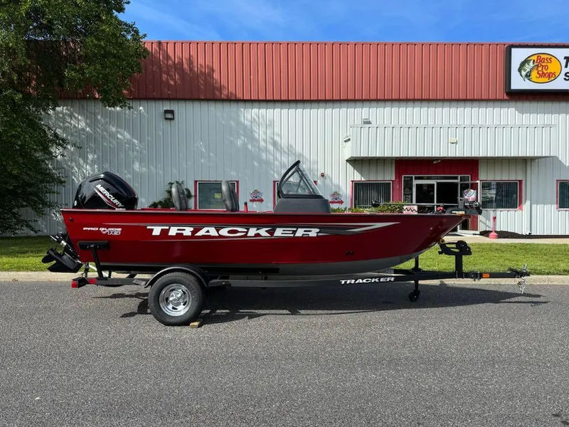 The Image of 2025 Tracker Pro Guide V-16 WT boat on trailer, parked outside a building. - 0