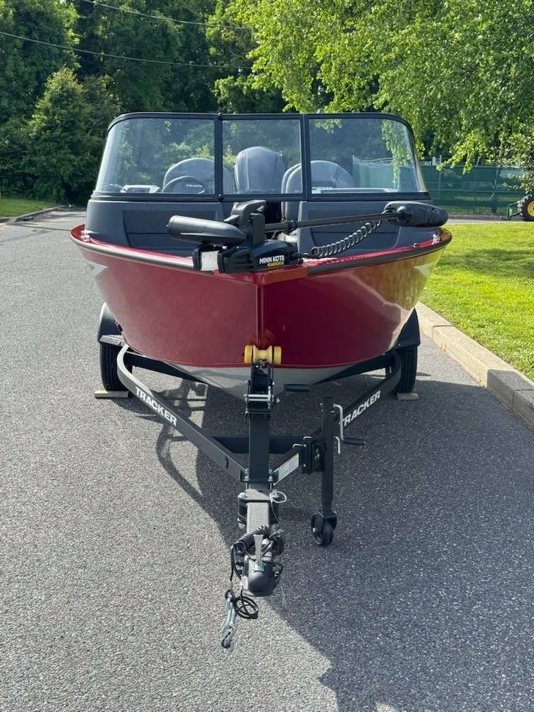 Slide: The Image of 2025 Tracker Pro Guide V-16 WT boat on trailer, parked on a sunny day. - 3