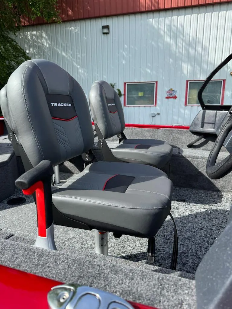 Slide: The Image of 2025 Tracker Pro Guide V-16 WT boat interior with gray seats and red accents. - 9