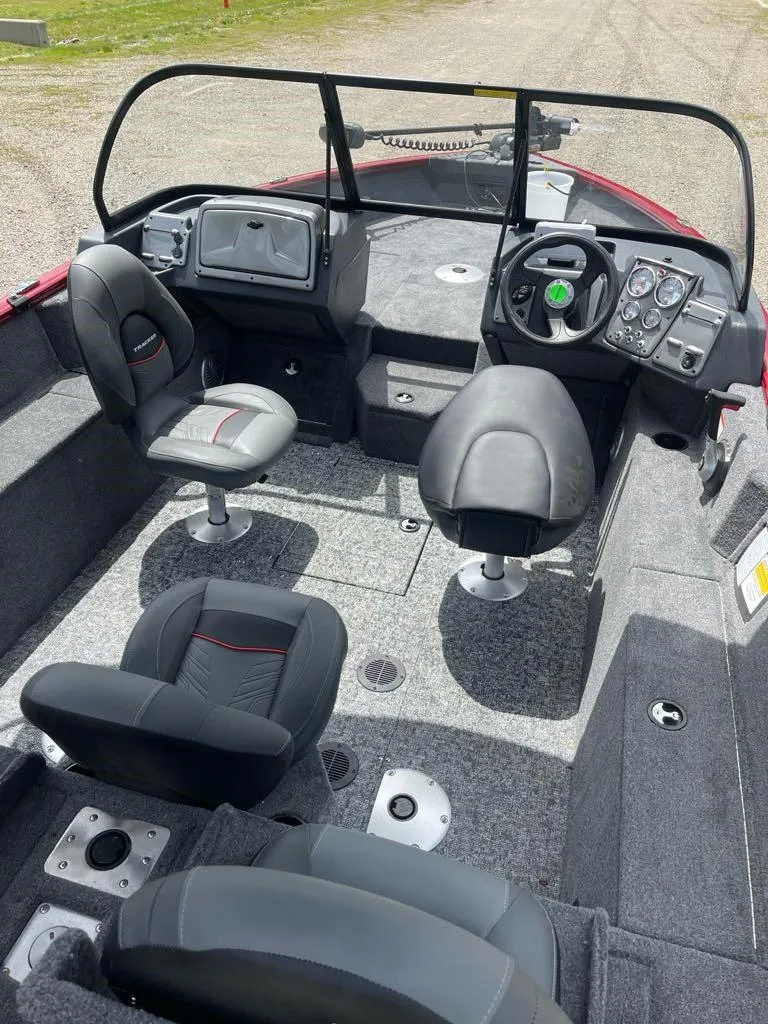 Slide: The Image of 2025 Tracker Pro Guide V-175 Combo boat interior with seating and dashboard controls. - 3