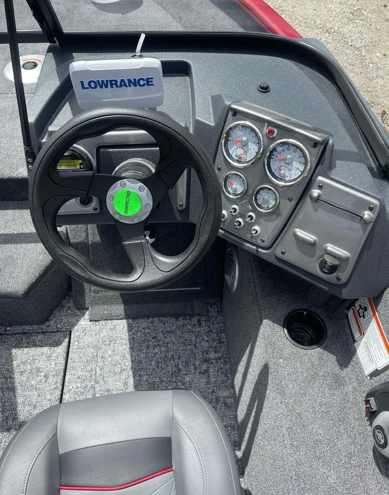 Slide: The Image of 2025 Tracker Pro Guide V-175 Combo boat dashboard with steering wheel and gauges. - 4