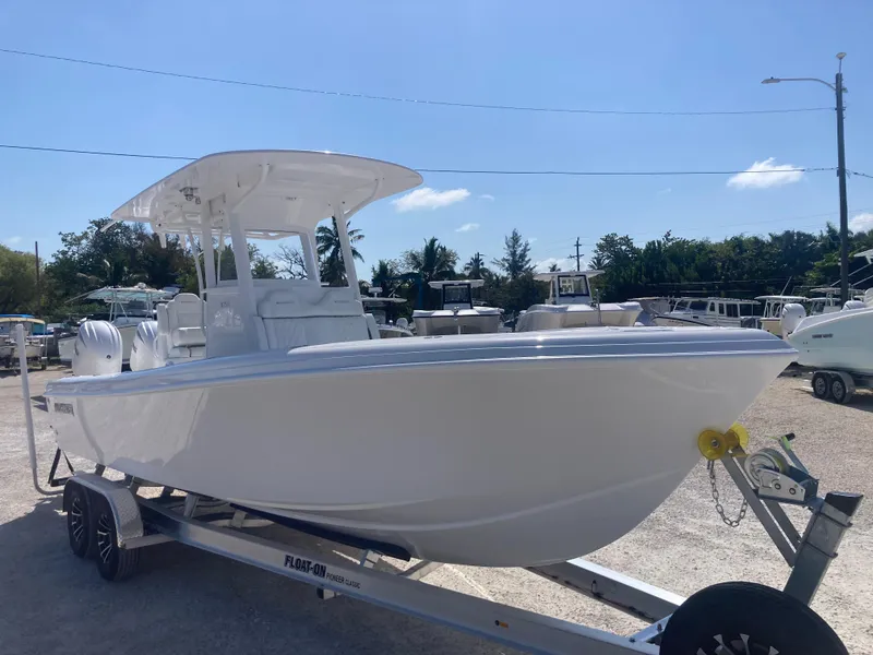 Slide: The Image of 2025 Bluewater II25T boat on trailer under clear sky. - 1