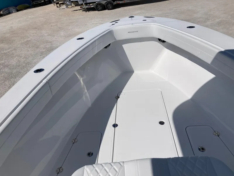 Slide: The Image of 2025 Bluewater II25T boat interior, featuring spacious white deck and seating area. - 14