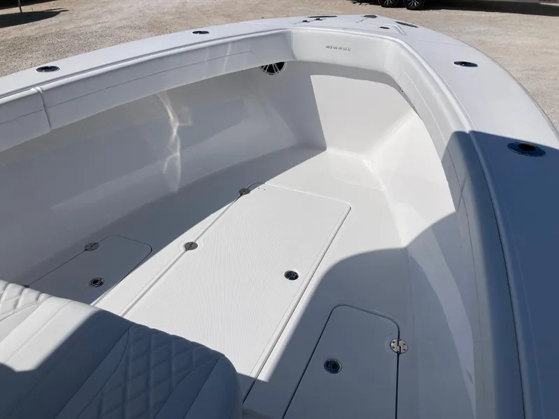 Slide: The Image of 2025 Bluewater II25T boat interior, featuring spacious white deck and seating area. - 15