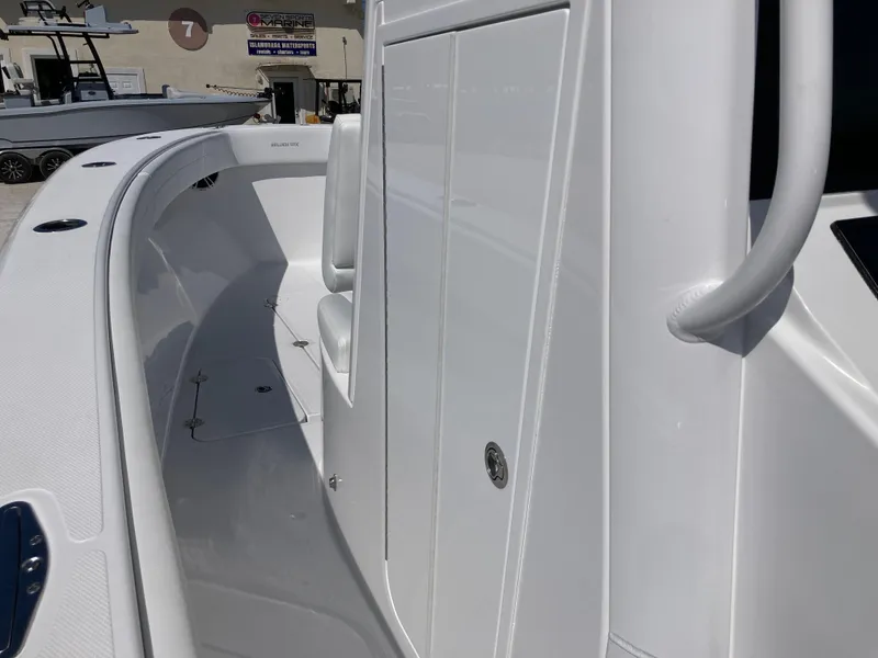 Slide: The Image of 2025 Bluewater II25T boat, sleek white deck and seating area, modern design. - 22