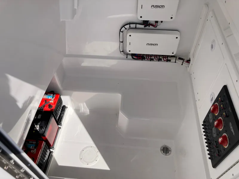 Slide: The Image of 2025 Bluewater II25T boat interior with electrical components and battery setup. - 24