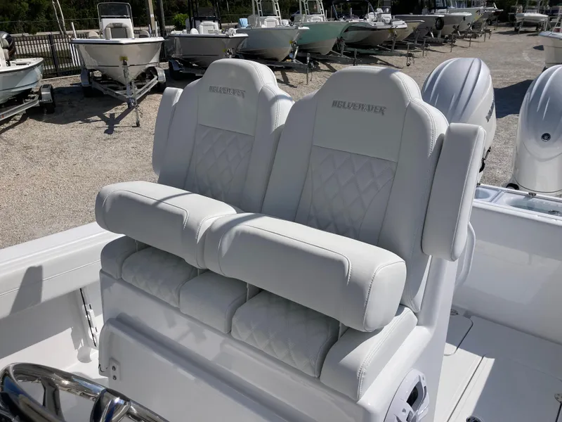 Slide: The Image of 2025 Bluewater II25T boat with luxurious white seating and dual engines. - 25