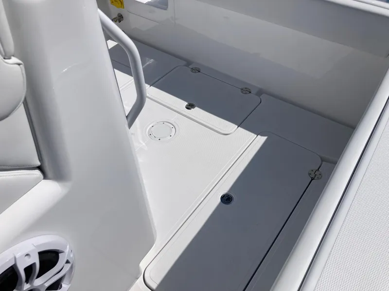 Slide: The Image of 2025 Bluewater II25T boat deck with storage compartments and speaker. - 27