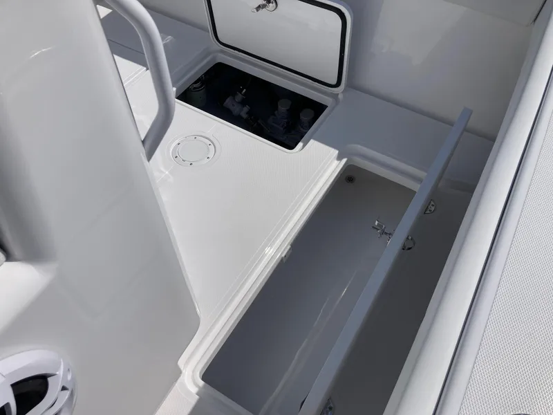 Slide: The Image of 2025 Bluewater II25T boat interior with open storage compartments and sleek design. - 28
