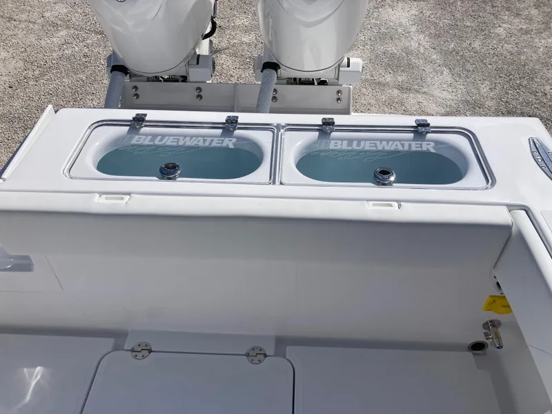 Slide: The Image of 2025 Bluewater II25T boat with dual livewells and twin outboard engines. - 30