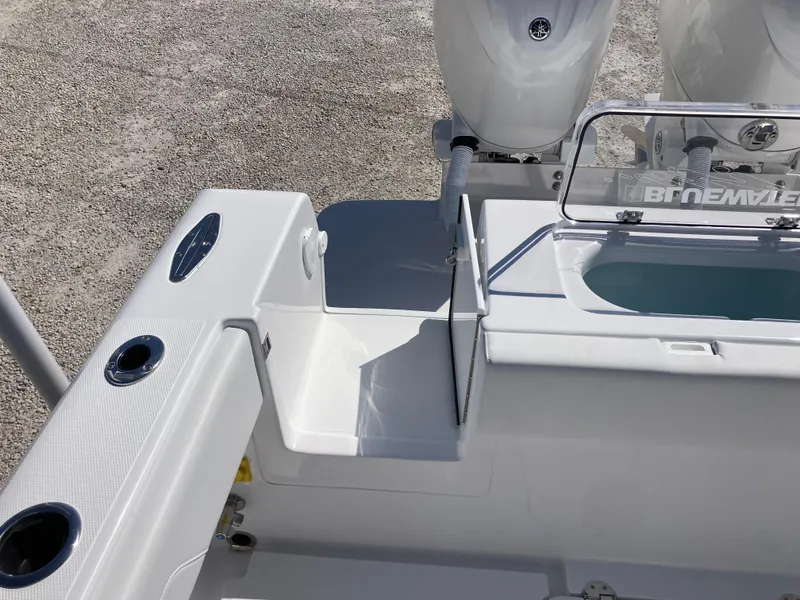 Slide: The Image of 2025 Bluewater II25T boat deck with dual engines and fishing rod holders. - 32