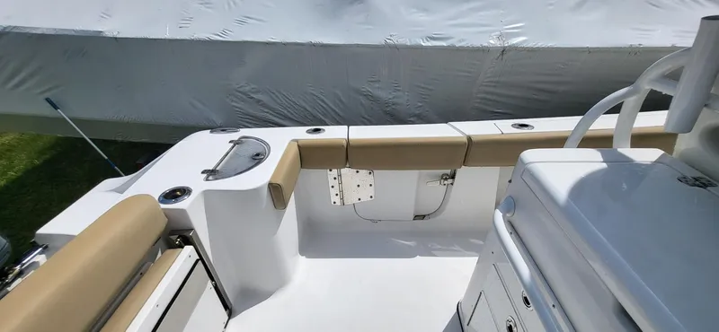 Slide: The Image of 2017 Sportsman Open 282 Center Console boat interior with seating and storage. - 10